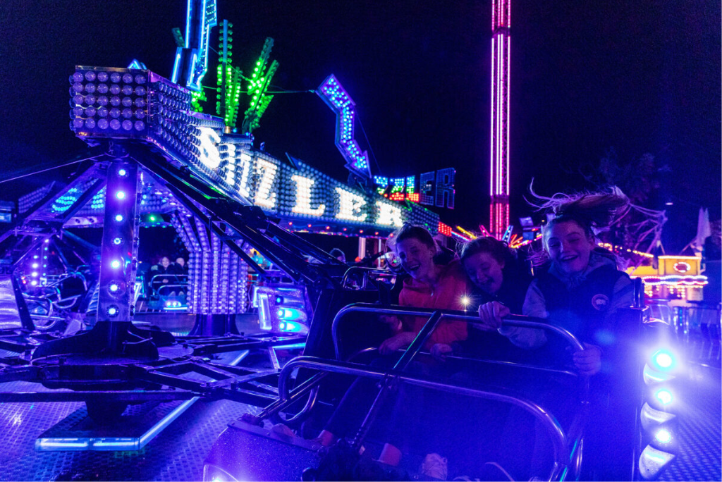 Happy kids laughing on The Sizzler ride at Spooktacular Silverburn