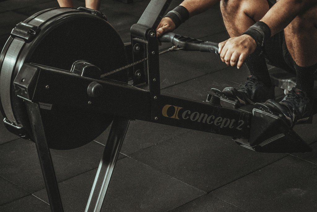 A man using a rowing machine in a gym