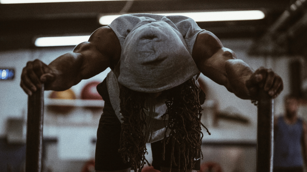 A man working out at a gym wearing a grey hoodie, training for Hyrox