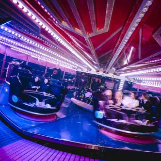 Guests riding the Waltzers at the Galactic Carnival