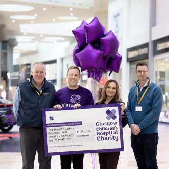 Silverburn staff holding a Glasgow Children's Hospital Charity cheque